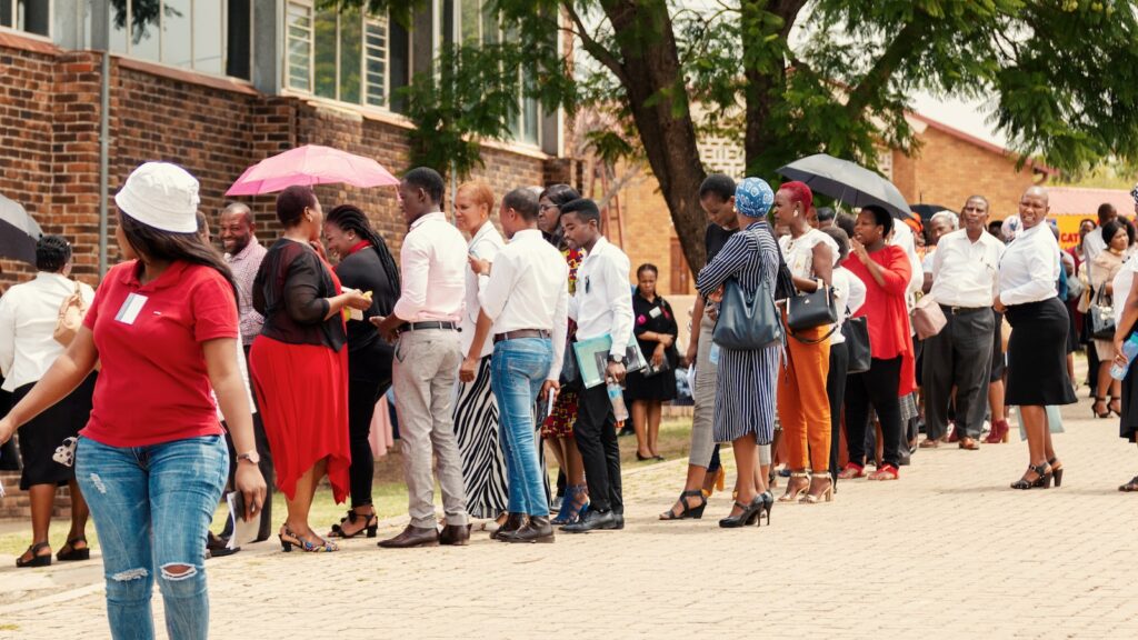 Employment - crowd of people near building waiting for job interview